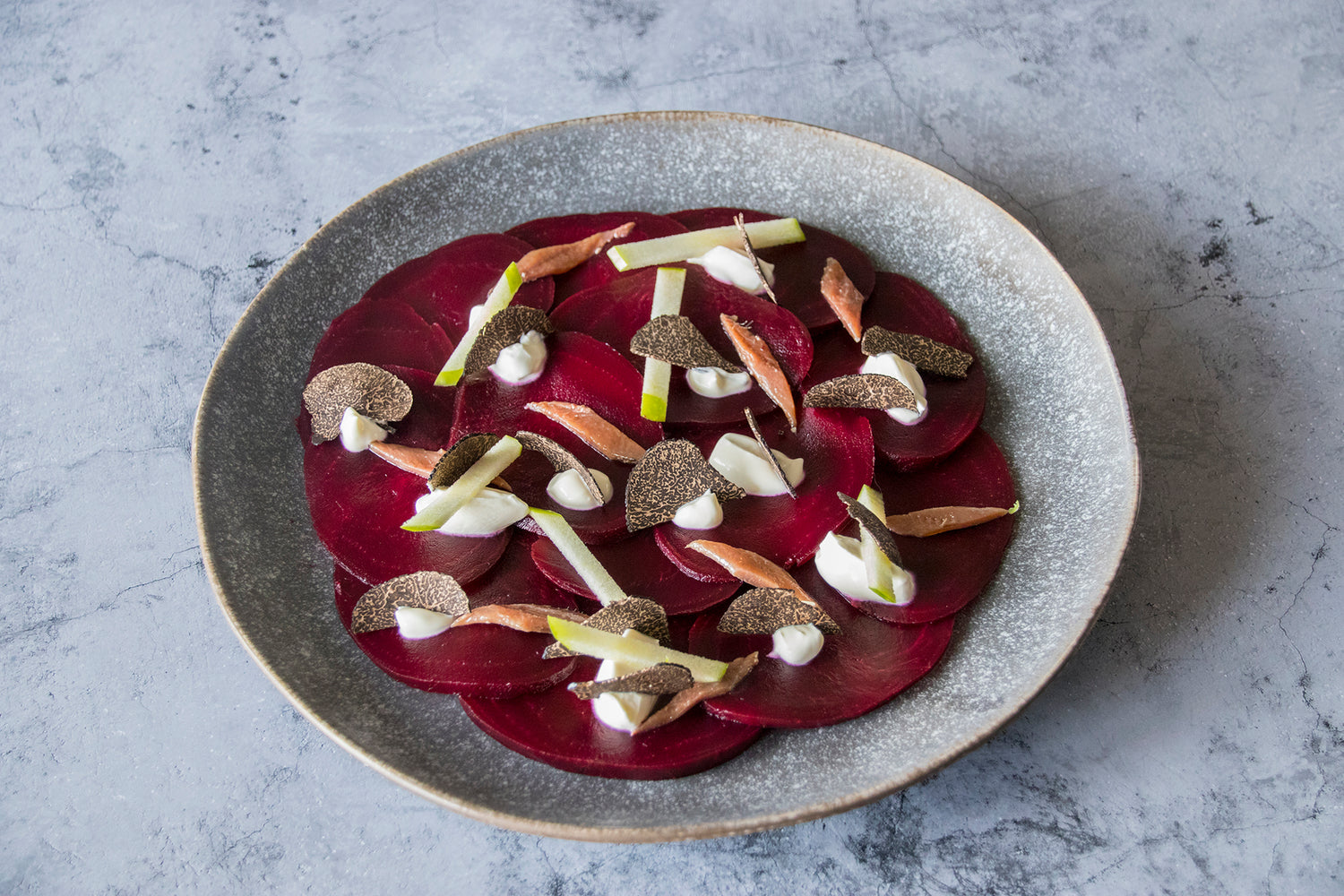 Beetroot carpaccio with crème fraîche, apple, anchovy and black truffle